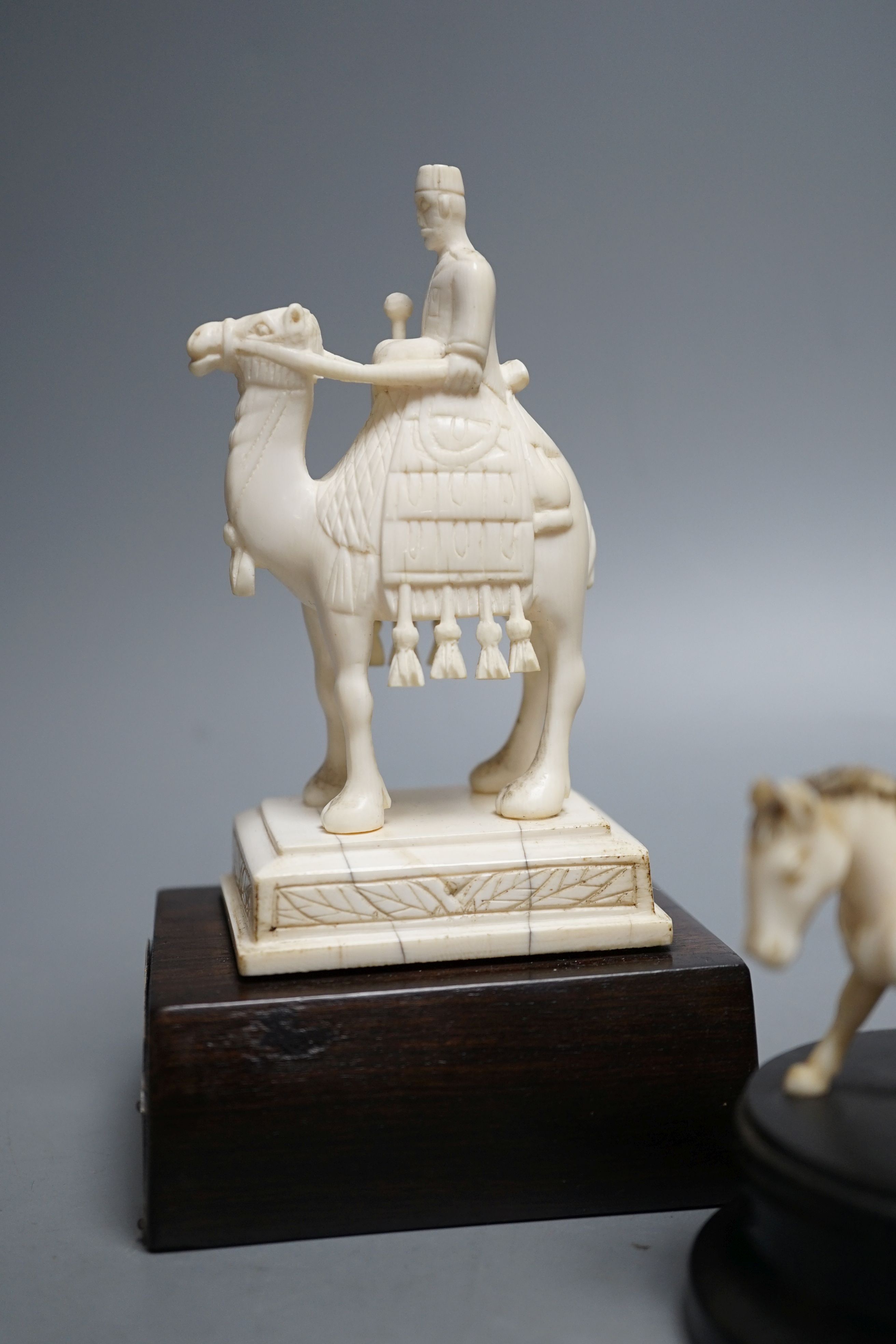An Indian ivory sedan chair, an ivory horse and an ivory man on camel (General Gordon) with white metal plaque, 19th/early 20th century , Ivory carving of a man on a camel 14.5cms high.